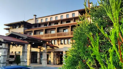 a large building in front of a building at Trinity Residence Bansko with Free Shuttle to Gondola in Bansko