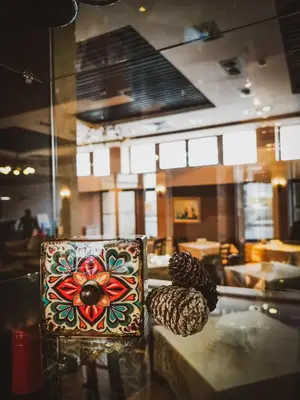 a box on a table with pine cones on it at Trinity Residence Bansko with Free Shuttle to Gondola in Bansko