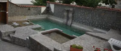 a minecraft pool with a waterfall in a yard at Angel&MAR in Velingrad