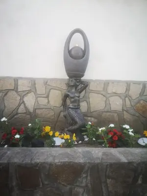 a statue of a water fountain in front of a wall at Angel&MAR in Velingrad