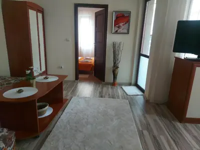 a bathroom with two sinks and a hallway with a door at Angel&MAR in Velingrad