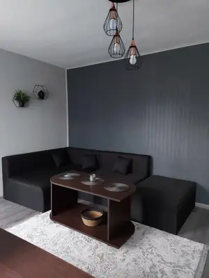 a living room with a black couch and a table at Angel&MAR in Velingrad