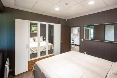 a bedroom with a white bed in a room at Apartment House - Delta in Sofia