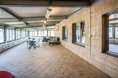 a large room with a table and chairs and windows at Apartment House - Delta in Sofia