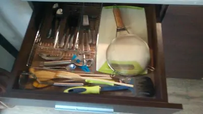 a wooden drawer filled with utensils and a spatula at Alexander 3327 in Bansko