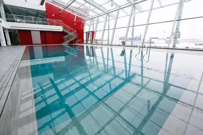 a swimming pool with a person standing in the water at Uva Nestum Wine & SPA in Gotse Delchev