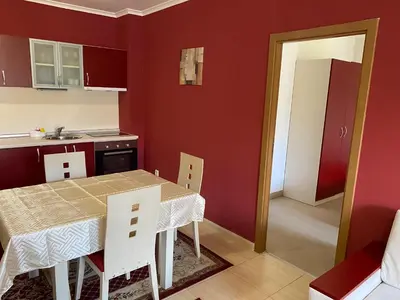 a kitchen with a table and chairs in a room at Червената Шапчица Апартамент Гранд Манастира in Pamporovo