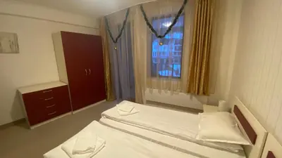 a small bedroom with a bed and a window at Червената Шапчица Апартамент Гранд Манастира in Pamporovo