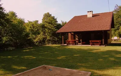 a large yard with a house with a roof at Boyana Vacation Houses in Cherni Vit
