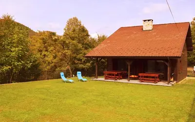 two blue chairs sitting in the yard of a house at Boyana Vacation Houses in Cherni Vit
