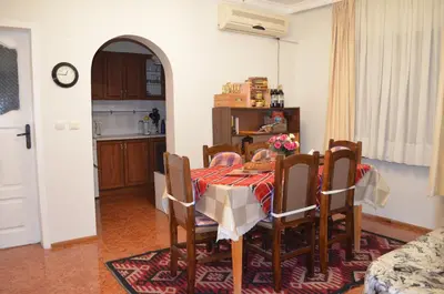 a kitchen and dining room with a table and chairs at Villa Bella - A Rila Monastery Adventure in Kocherinovo