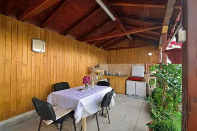 a kitchen with a table and chairs in a room at Villa Bella - A Rila Monastery Adventure in Kocherinovo