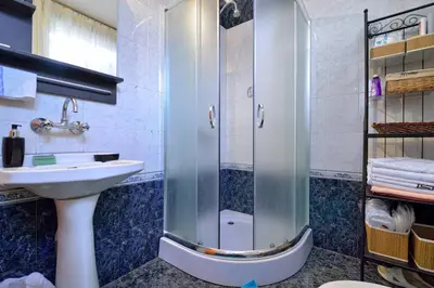 a bathroom with a shower and a sink and a sink at Villa Bella - A Rila Monastery Adventure in Kocherinovo