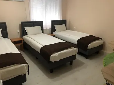 a room with two beds and a window at Къща ИВОНА in Sapareva Banya