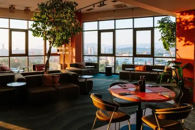 a room with couches and tables and windows at WorkNomads LAB Hotel in Sofia