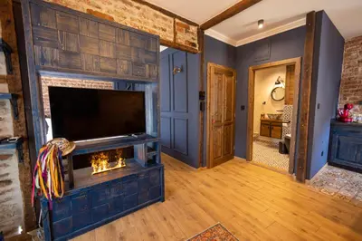 a living room with a fireplace and a tv at NOMAD STUDIOS, Kapana in Plovdiv