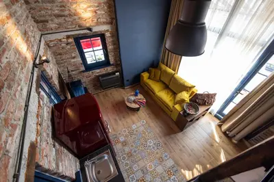 an overhead view of a living room with a yellow couch at NOMAD STUDIOS, Kapana in Plovdiv