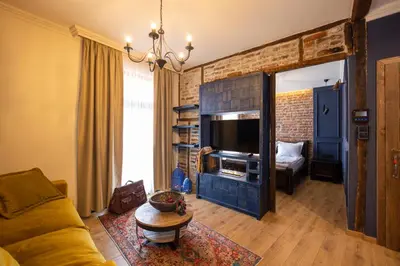 a living room with a couch and a television at NOMAD STUDIOS, Kapana in Plovdiv
