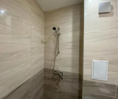 a bathroom with a shower with a glass door at Brand new and modern apartment directly next to the metro station in Sofia