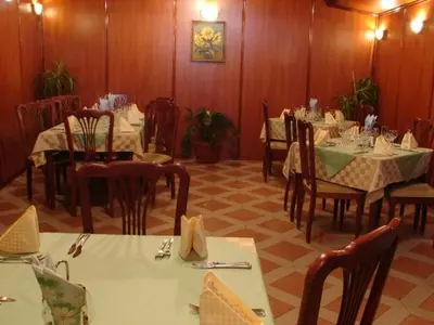 a dining room with tables and chairs in a restaurant at Darling Hotel in Sofia