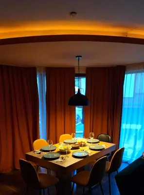 a dining room with a table and chairs with wine glasses at Villa Carpe Diem in Pamporovo