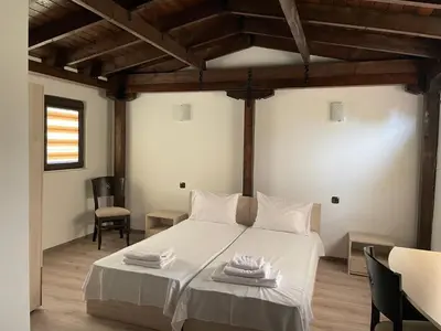 a bedroom with a white bed with towels on it at Apart Uzunov-3 in Hisarya