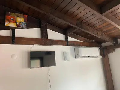 a tv hanging on a wall in a room at Apart Uzunov-3 in Hisarya