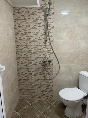 a bathroom with a shower with a toilet at Apart Uzunov-3 in Hisarya