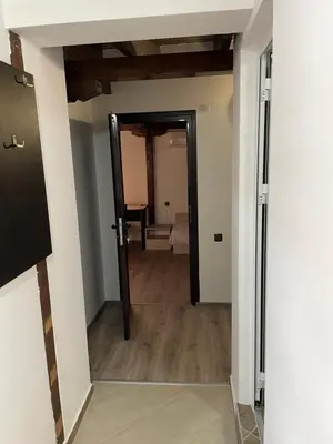 a hallway with a door leading into a room at Apart Uzunov-3 in Hisarya
