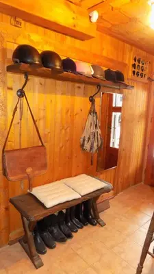 a wooden room with a bench with pots and pans at Dona Guest House - Horse Riding in Koprivshtitsa