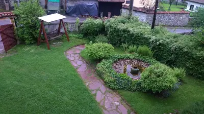 a garden with a heart made out of plants at Dona Guest House - Horse Riding in Koprivshtitsa