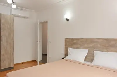 a bedroom with a large bed with white pillows at Апартамент за гости Дарива in Smolyan