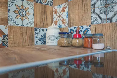 a shelf with jars of condiments on it at Temple House in Plovdiv