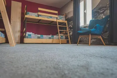 a room with two bunk beds and a chair at Temple House in Plovdiv