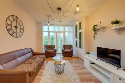 a living room with a couch and a tv at ИНвела in Smolyan