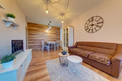 a living room with a couch and a table at ИНвела in Smolyan