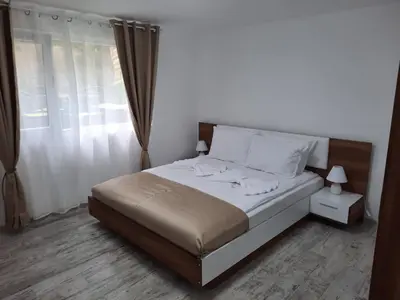 a bedroom with a bed and a window at Апартаменти за гости ,,Тракия'' in Hisarya