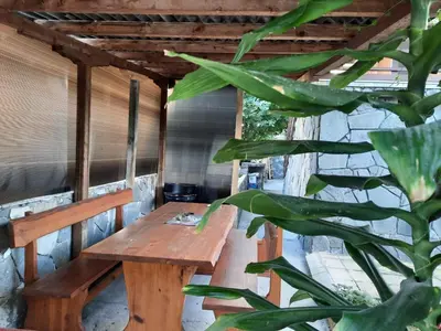 a wooden bench in a room with a plant at Апартаменти за гости ,,Тракия'' in Hisarya