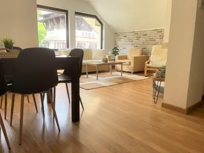 a living room with a table and chairs at Private Apartment Laplandia 77 (Pamporovo, Bulgaria) in Pamporovo