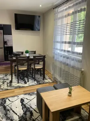 a dining room with a table and a television at Св.Георги in Sapareva Banya