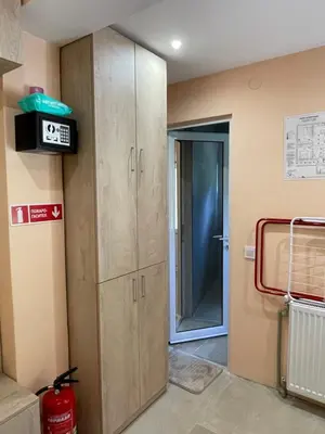 a room with two wooden cabinets next to a door at Св.Георги in Sapareva Banya