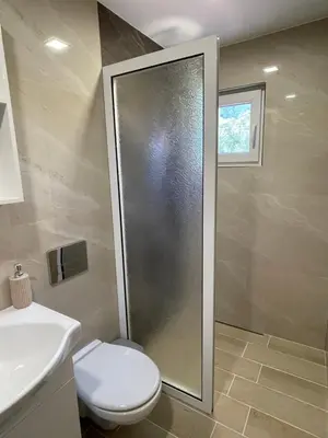 a bathroom with a shower and a toilet and a sink at Св.Георги in Sapareva Banya