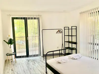 a white room with a bed and a window at Nordic Style Apartment with Parking place in Sofia