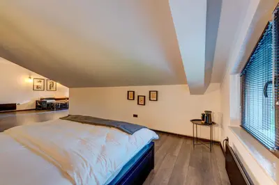 a bedroom with a bed and a large window at Black Box Studio in Smolyan