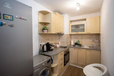 a small kitchen with a sink and a dishwasher at Karastoyanovi's apartment 2 in Sofia