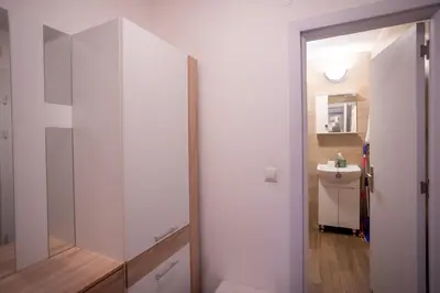 a bathroom with a toilet and a sink and a mirror at Karastoyanovi's apartment 2 in Sofia