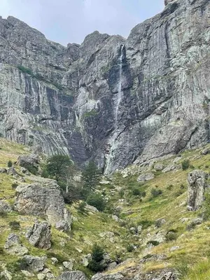 a waterfall on the side of a rocky mountain at Комплекс Омайник in Kalofer