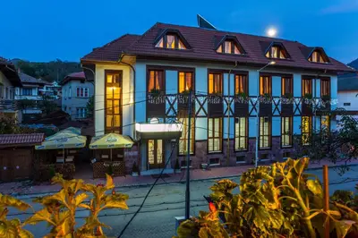 a building with lights on in front of it at Family Hotel Teteven in Teteven