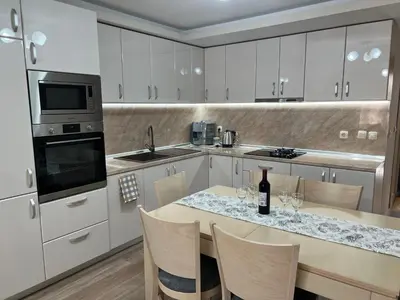 a kitchen with a table with wine glasses on it at Къща за гости ТАТЯНА / GUEST HOUSE TATIANA in Petrich