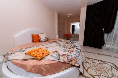 a bedroom with a bed with a blanket on it at Sandanski Peak Guest Rooms in Sandanski